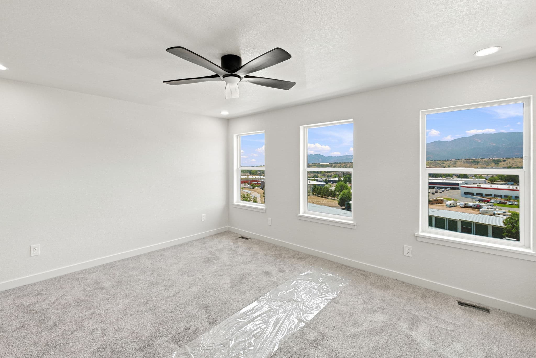 Primary bedroom with mountain views from three windows